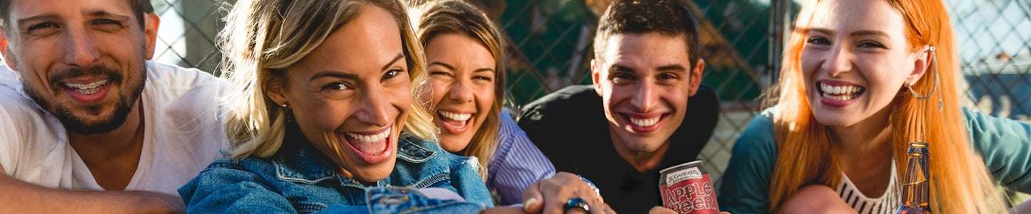 Group of friends taking a selfie outdoors with a clear sky background