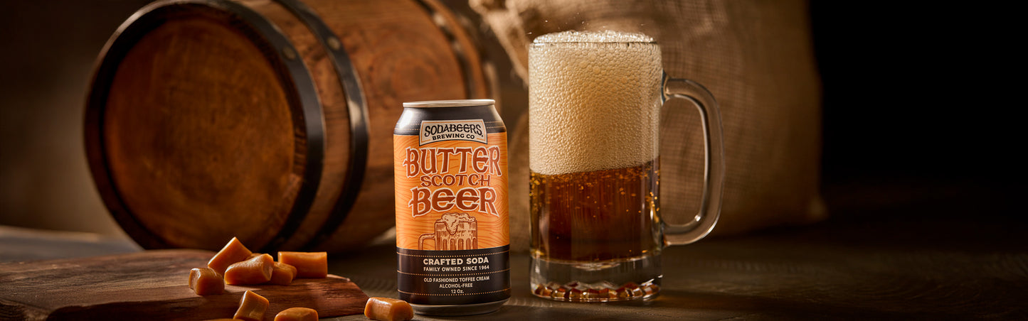 Butterbeer can and glass with a wooden barrel in the background