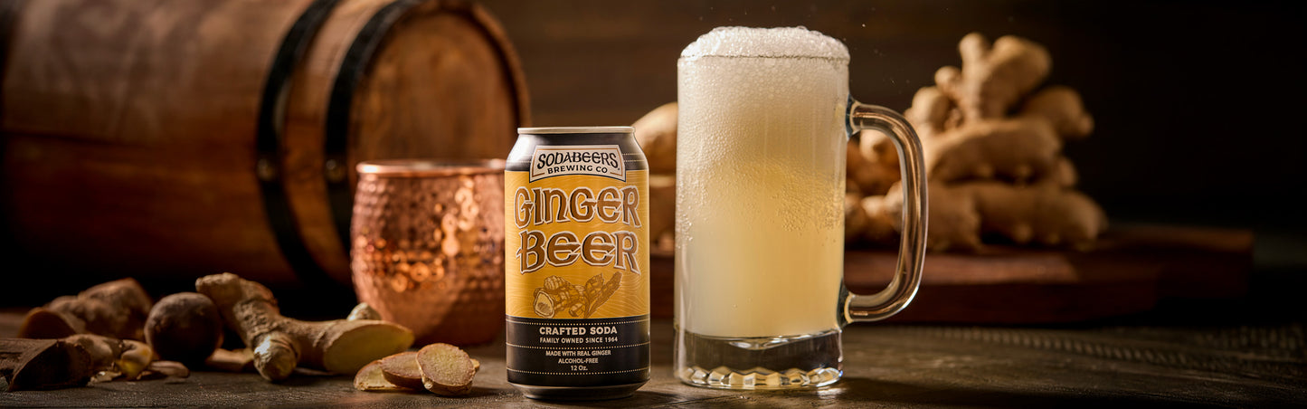 Can of SodaBeers Ginger beer with a glass of ginger beer and ginger root on a wooden surface.